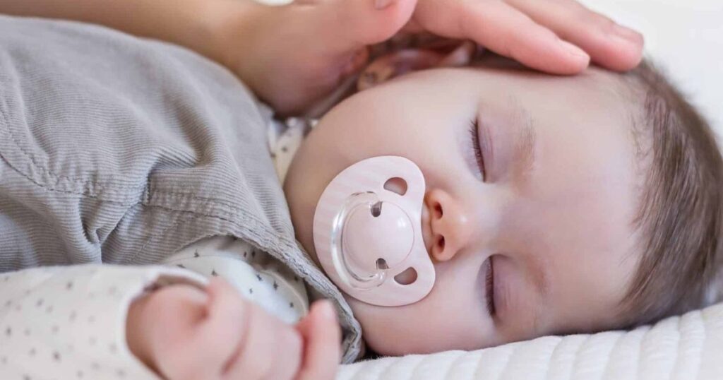 baby sleeping with pacifier in mouth