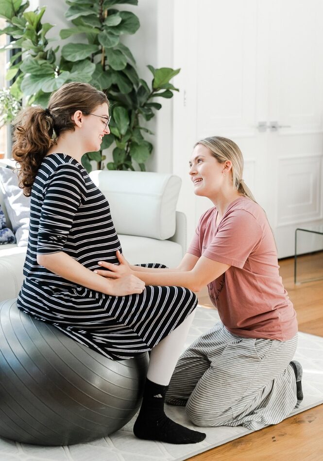 Birth Doula Services Philadelphia supporting pregnant woman on birth ball